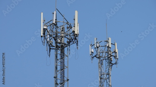 Cell tower antennas soar into blue sky