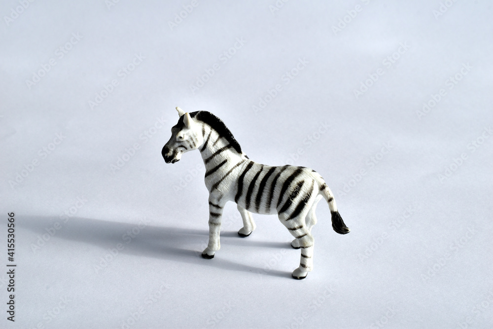Fototapeta premium Children's toy. Zebra on white. Made of plastic. Side view.