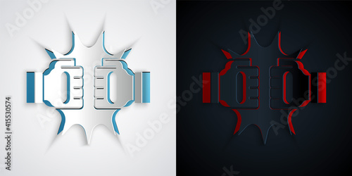 Paper cut Punch in boxing gloves icon isolated on grey and black background. Boxing gloves hitting together with explosive. Paper art style. Vector.