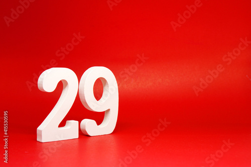 Twenty Nine ( 29 ) white number wooden Isolated Red Background with Copy Space - New promotion 29% Percentage Business finance Concept 