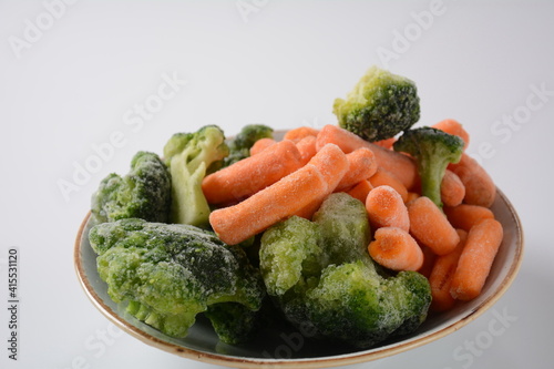 Small frozen pieces of broccoli and carrots. Healthy food. Frozen vegetables