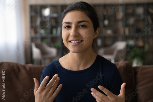 Canvastavla Close up screen view portrait of smiling millennial Indian woman look at camera talk speak on video call