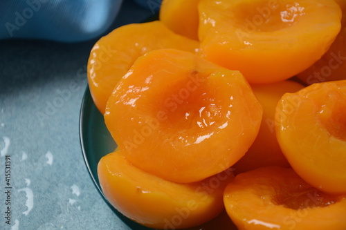 Sweet canned peaches in the ceramic bowl