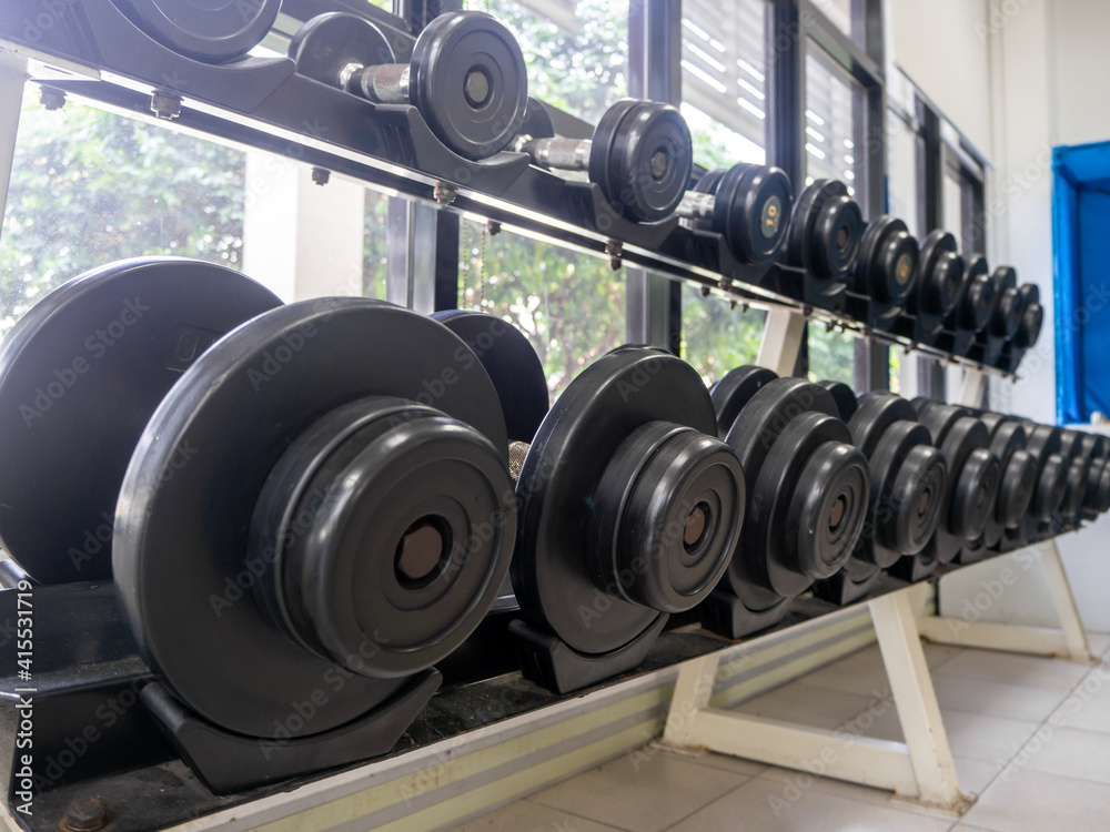 dumbbell set. Close up many metal dumbbells