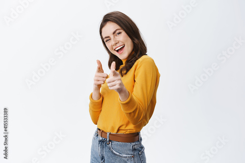 You got this. Friendly smiling woman congrats, pointing at camera and smiling, praising good jog, inviting to event, standing on white background