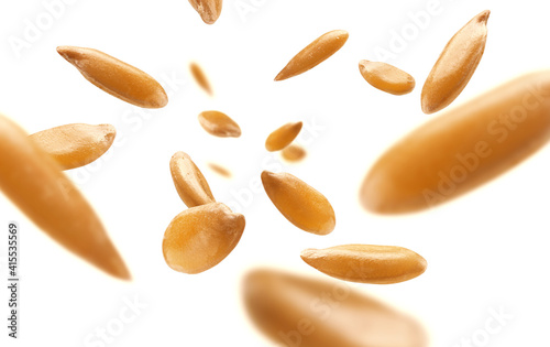 Flax seeds are levitated on a white background
