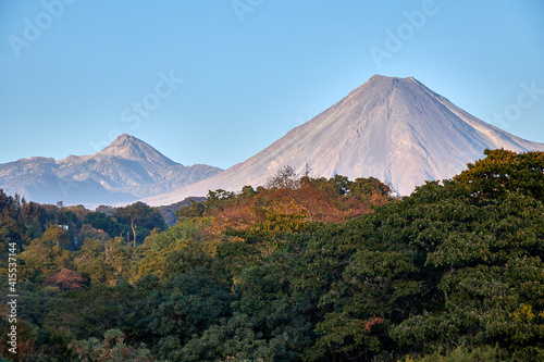 volcanoes with blue sky and vegetation