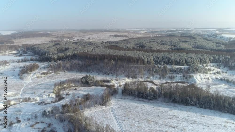 Forest in the snow, flying over frozen trees and fields Forest in the snow, flying over frozen trees and fields