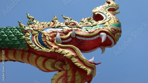 Mythical Naga soaring into blue sky photo