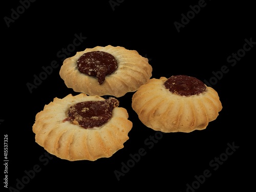 cookies with jam on black background