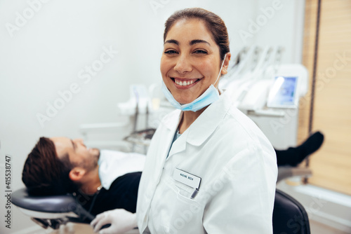 Smiling female dentist in dental hospital