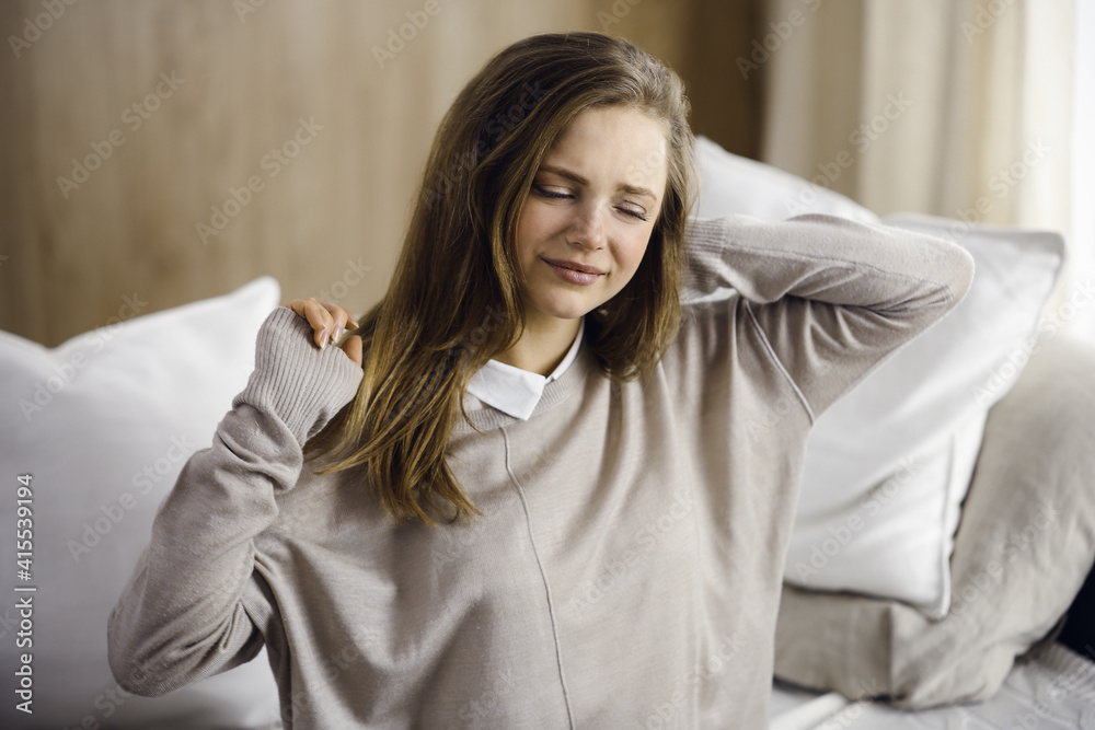 Tired woman massaging rubbing stiff sore neck tensed muscles fatigue from computer work in incorrect posture. Stay at home concept during Coronavirus pandemic and self isolation quarantine Tired woman massaging rubbing stiff sore neck tensed muscles fatigue from computer work in incorrect posture. Stay at home concept during Coronavirus pandemic and self isolation quarantine