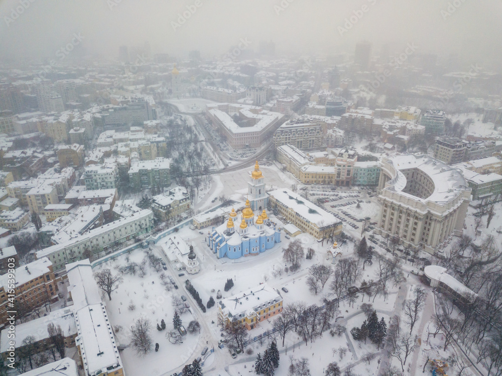 St. Michael's Cathedral in Kiev in a blizzard. Aerial drone view. Snowy winter morning, blizzard.
