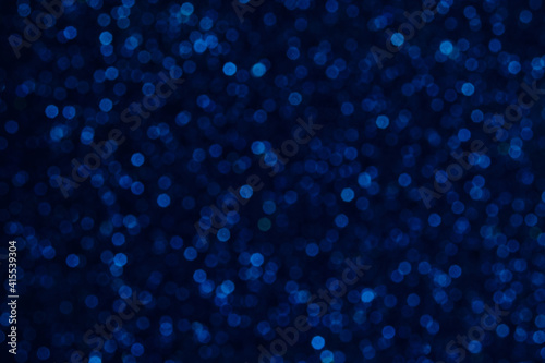 Abstract background with blue blurred round bokeh.
