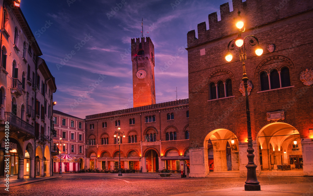 14 february 2021, Treviso, Italy: Piazza dei Signori (Lord's Square) in Treviso at dawn. On the background the city Tower, on the right Palazzo dei Trecento