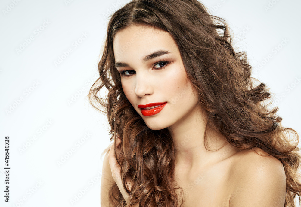 Woman with curly hair bright makeup portrait close-up and shadows on the eyelids Woman with curly hair bright makeup portrait close-up and shadows on the eyelids