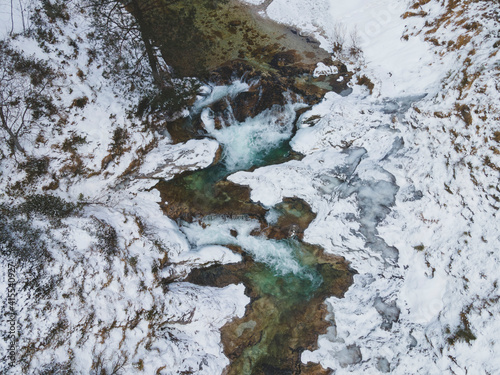 Aerial drone shot of snowy and icy winter landscape in the oetschergraeben in austria