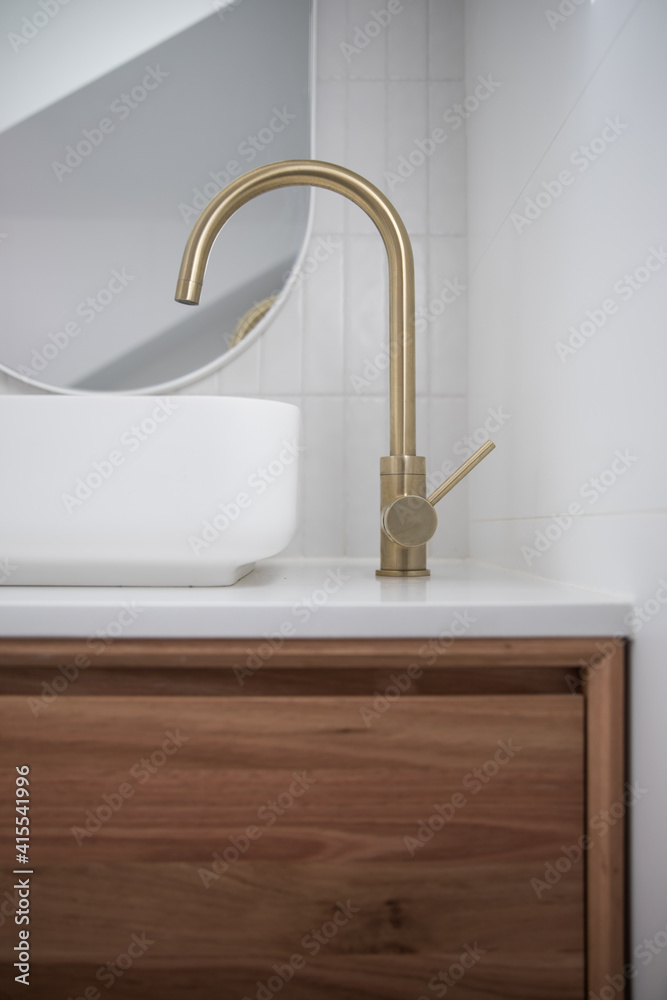Modern white bathroom stone benchtop timber vanity gold brass tap sink mirror tiled wall elegant natural light renovation new 