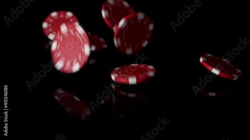 Many red poker chips falling in sow motion on reflective black backdrop