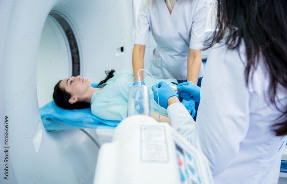 Radiologist with a female patient in the room of computed tomography Radiologist with a female patient in the room of computed tomography