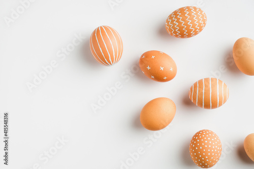 Happy Easter card. Simple painted Easter eggs isolated on white background. Flat lay, top view