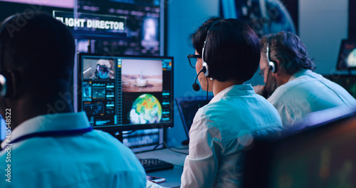 Multiracial operators working in flight control center