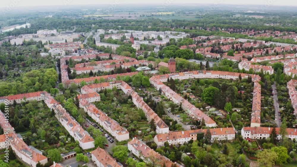 Aerial view of geometrical neighborhood in a green environment. Blocks of flats from drone. Symmetrical buildings from above.