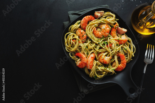 Pasta with shrimps and pesto on plate