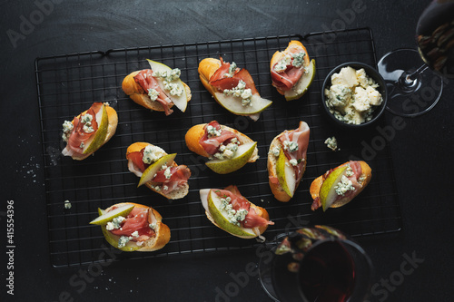 Small appetizers with prosciutto on board