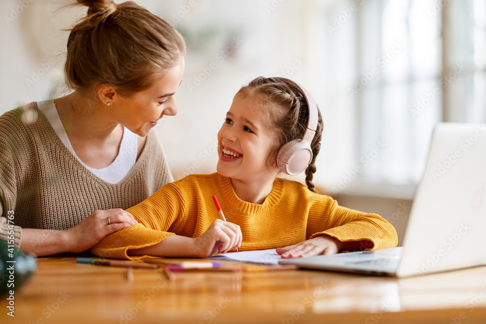 Happy mother supporting daughter during online studies Happy mother supporting daughter during online studies
