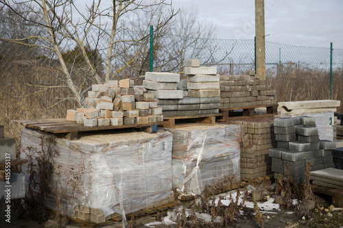 Pavement-Stacks of new concrete paving slabs on wooden pallets