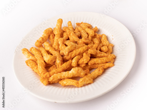 Kurkure on plate isolated stock image with white background.