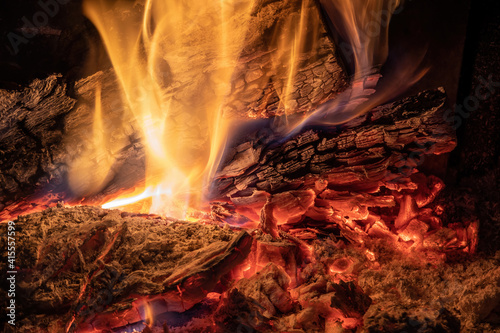 Burning billets in fireplace as abstract background