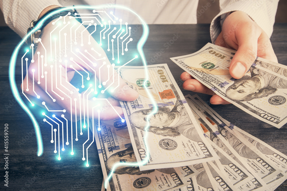 Multi exposure of brain drawing hologram and us dollars bills and man hands. Ai invest concept Multi exposure of brain drawing hologram and us dollars bills and man hands. Ai invest concept