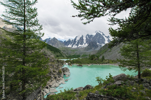 The pearl of the Altai Mountains, the upper lake Shavlo, above which rise three glacier-covered peaks-A fairy tale, a Dream and a Beauty. The water in the lake has an amazing turquoise color