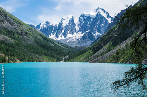 The pearl of the Altai Mountains, Lake Shavlo, with three glacier-covered peaks towering above it, is a Fairy tale, a Dream and a Beauty that is reflected in the lake water.
