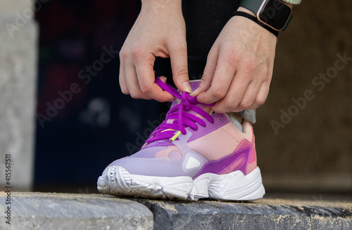 a close-up of a person tying shoelaces