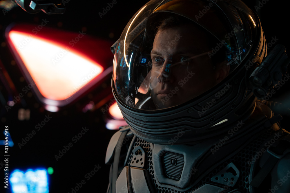Portrait of Caucasian male astronaut inside spaceship cockpit. Sci-fi space exploration concept. Mars mission
