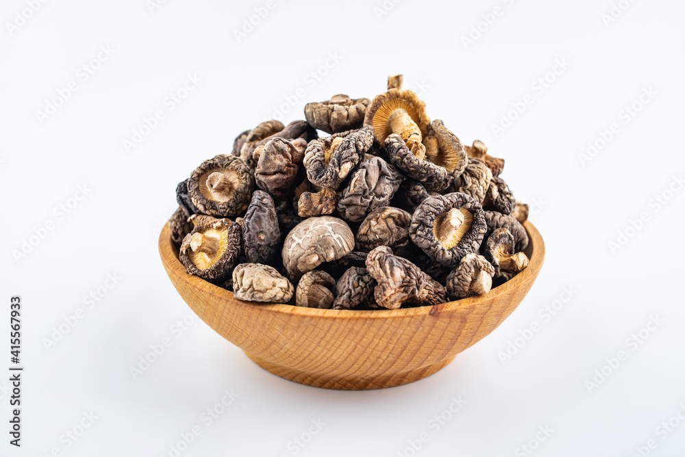 Dried small shiitake mushrooms on white background Dried small shiitake mushrooms on white background