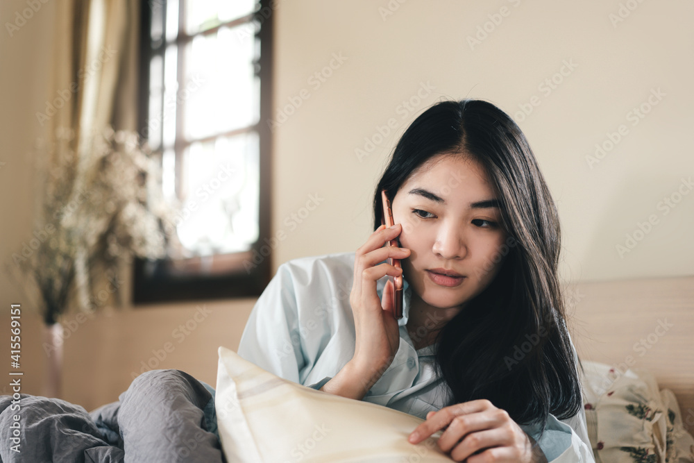 Young adult lonely single woman using smartphone in the moring for telemedicine and mental health. Young adult lonely single woman using smartphone in the moring for telemedicine and mental health.