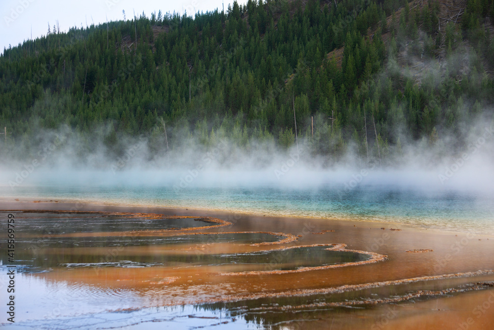 A side view of the Grand Prismatic Springs in Yellowstone National Park as steam is rising from the multi-colored waters.
A side view of the Grand Prismatic Springs in Yellowstone National Park as steam is rising from the multi-colored waters.