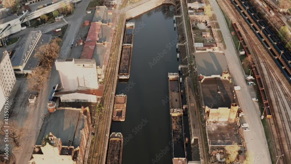 Aerial view of city shipyard. Industrial drone shot. Rusty docks during sunset. Aerial view of city shipyard. Industrial drone shot. Rusty docks during sunset.