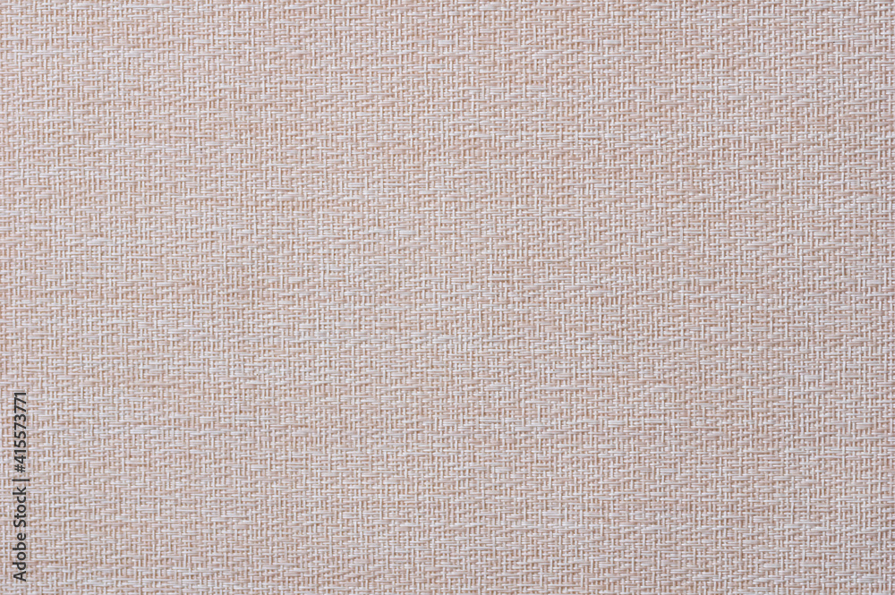 Fototapeta premium Close-up of a pattern of fabric imitating a natural canvas. Beige.