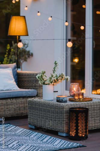 Summer evening on the patio of beautiful suburban house with garden