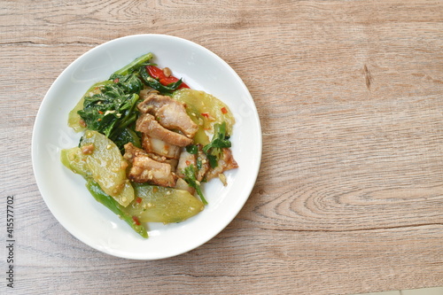 stir fried Chinese kale with crispy pork in soybean sauce on plate