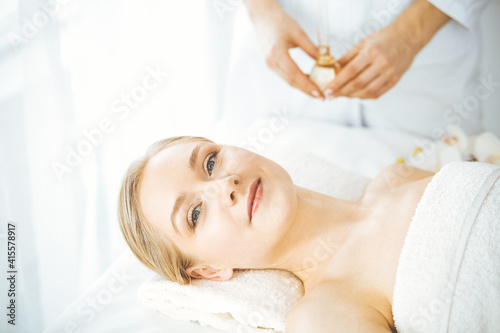 Happy beautiful woman smiles before spa procedures getting. Beauty and joy concept