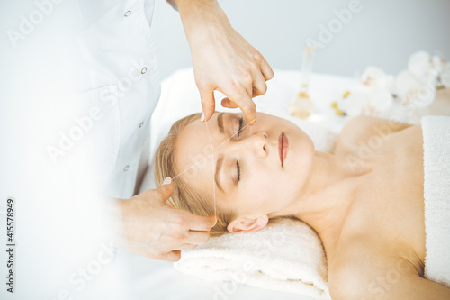 Beautiful caucasian woman getting face depilation procedure. Beauty and Spa salon concept