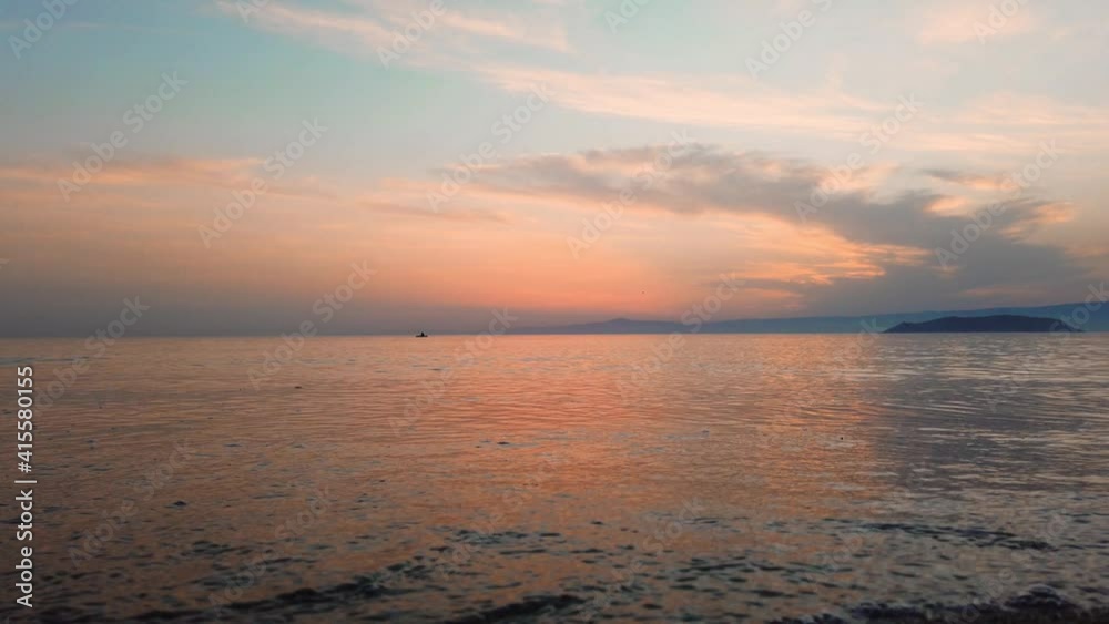Summer concept: Relaxing sea view of a colorful and dramatic sunset or romantic sunrise reflecting over the sea with focus on water. Tranquility and peace. Meditation. Natural sky and sea background Summer concept: Relaxing sea view of a colorful and dramatic sunset or romantic sunrise reflecting over the sea with focus on water. Tranquility and peace. Meditation. Natural sky and sea background