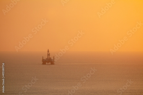 sea work rig oil sunset on the horizon