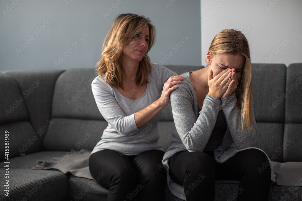 Depressed teen suffering from anxiety being taken care of by her caring mother Depressed teen suffering from anxiety being taken care of by her caring mother